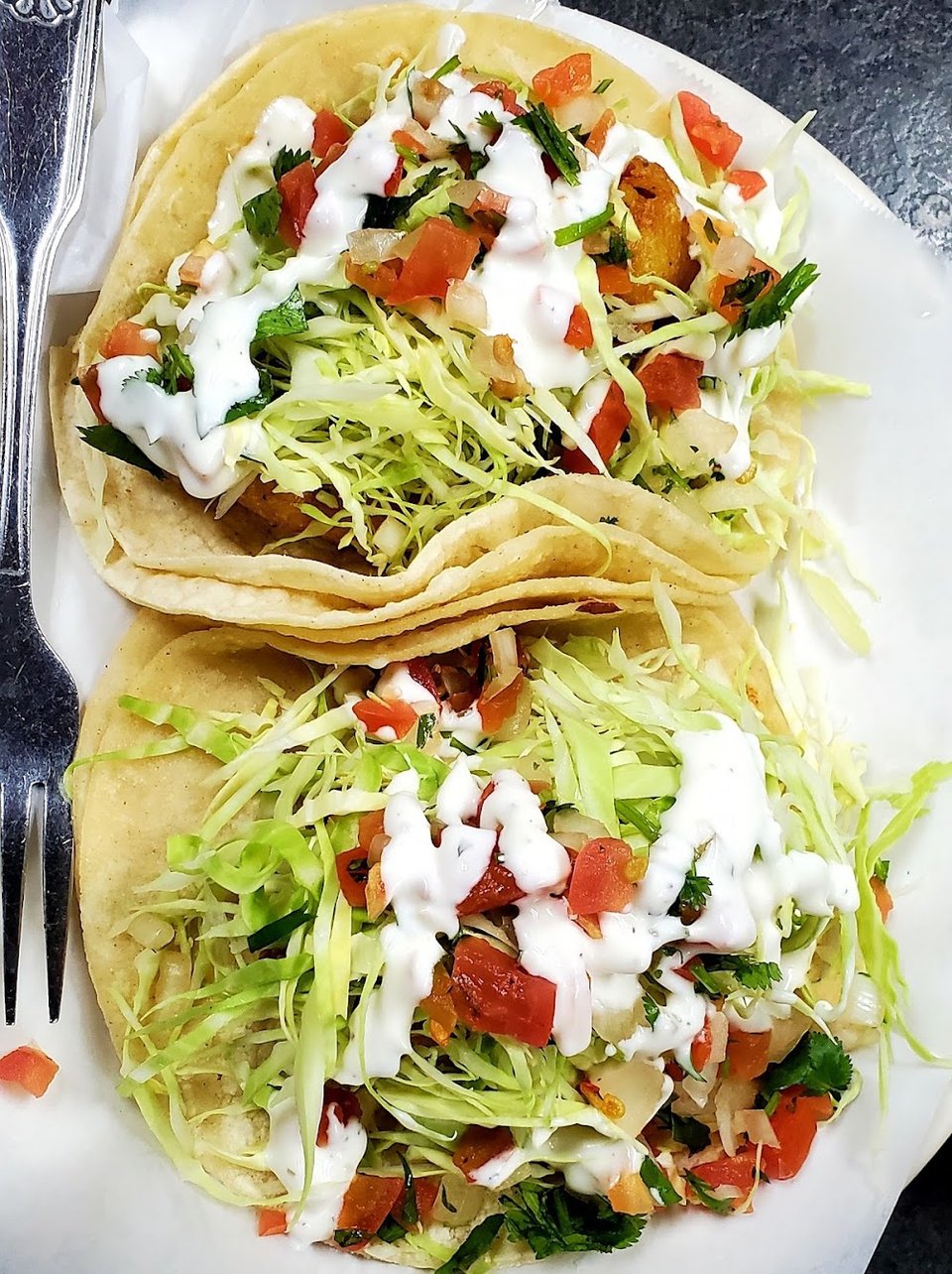 Food and beverage menu with Spanish headings.